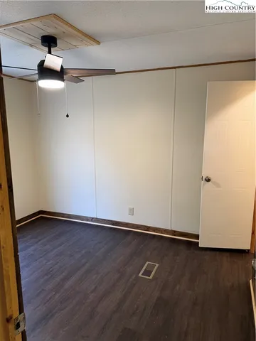 a view of a room with wooden floor