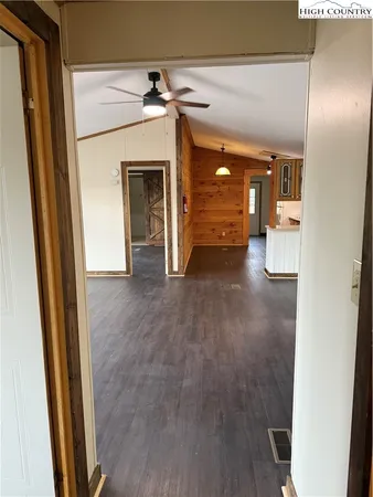 a view of a hallway with wooden floor and a fireplace