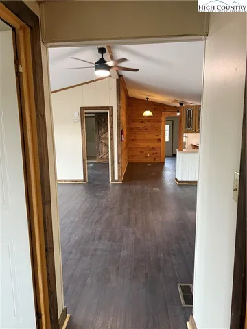 a view of a hallway with wooden floor and a fireplace