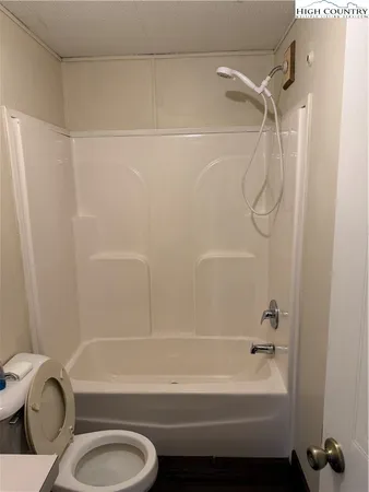 a bathroom with a shower a toilet and a shower
