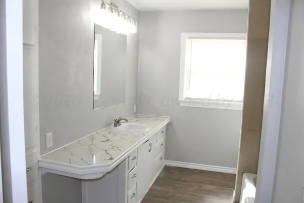 a bathroom with a sink and a window