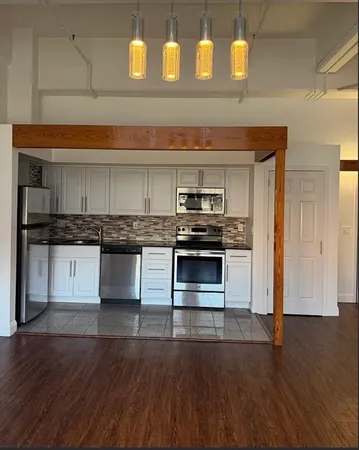 a view of a room with wooden floor