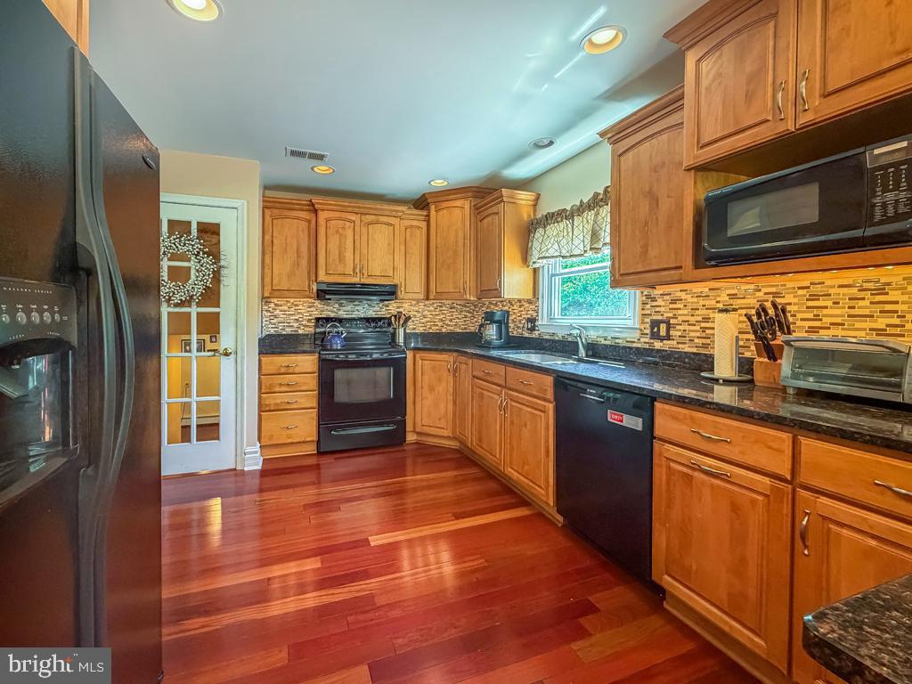 925 Big Oak Road Yardley, PA 19067 - Photo 18 of 51 a kitchen with stainless steel appliances granite countertop a stove a sink and a microwave