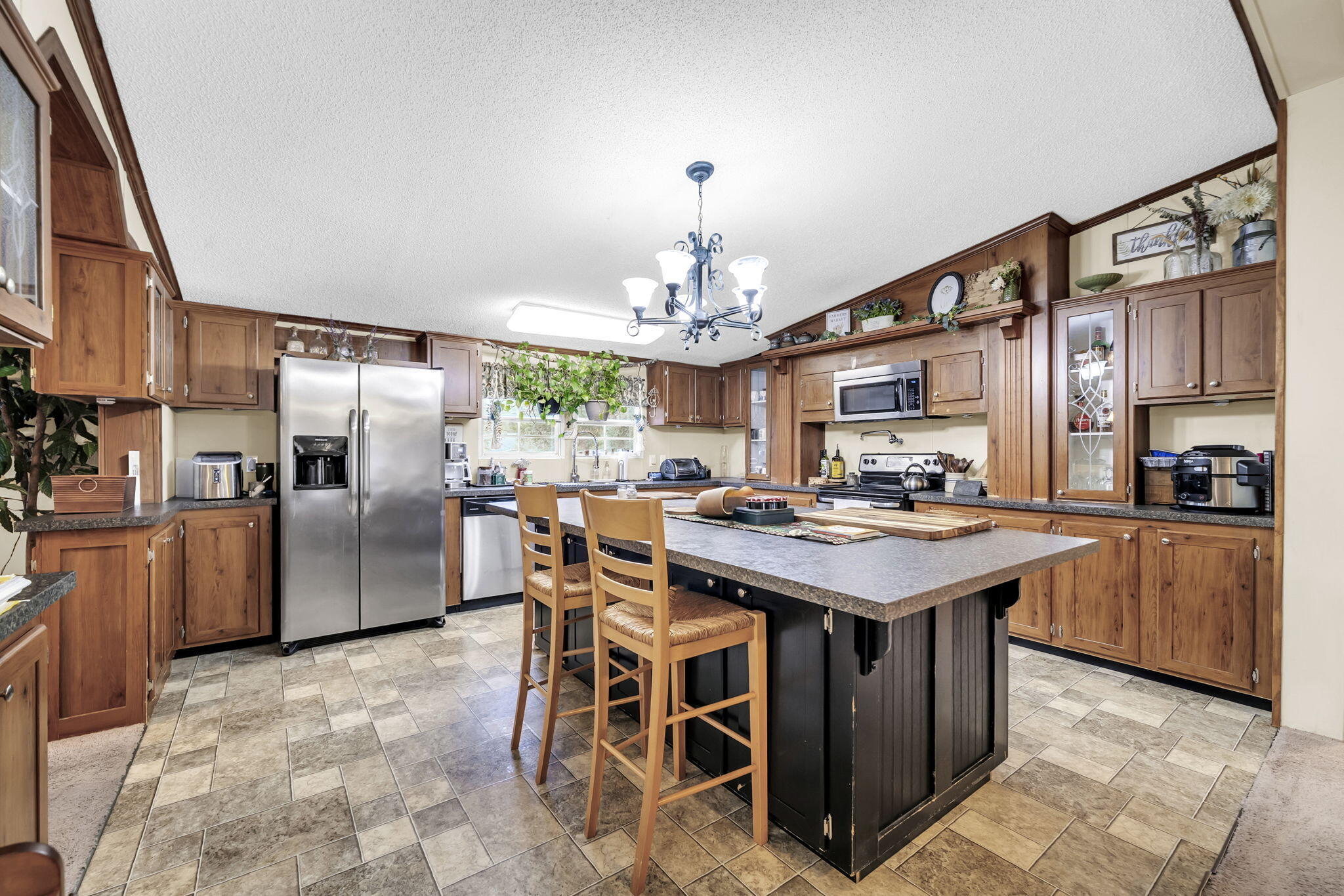1422 Cat-Mar Road Niceville, FL 32578 - Photo 16 of 35 a kitchen with stainless steel appliances granite countertop a stove a refrigerator a sink dishwasher with a dining table and chairs