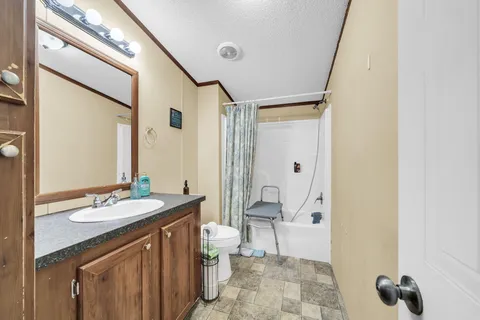 a spacious bathroom with a sink and a mirror