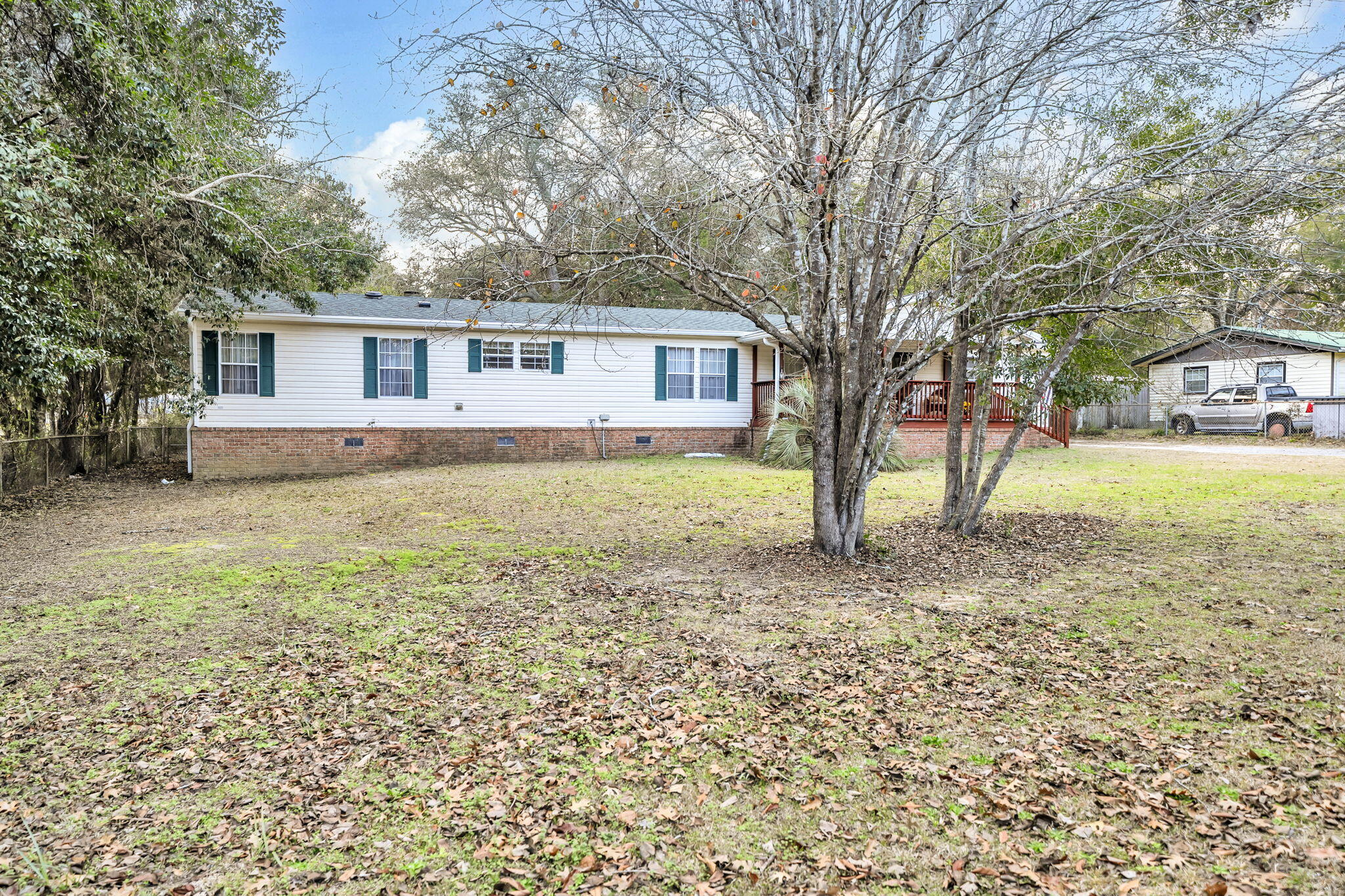 1422 Cat-Mar Road Niceville, FL 32578 - Photo 3 of 35 a front view of a house with a yard and trees