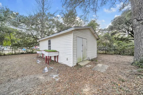 a view of a house with a yard and sitting area