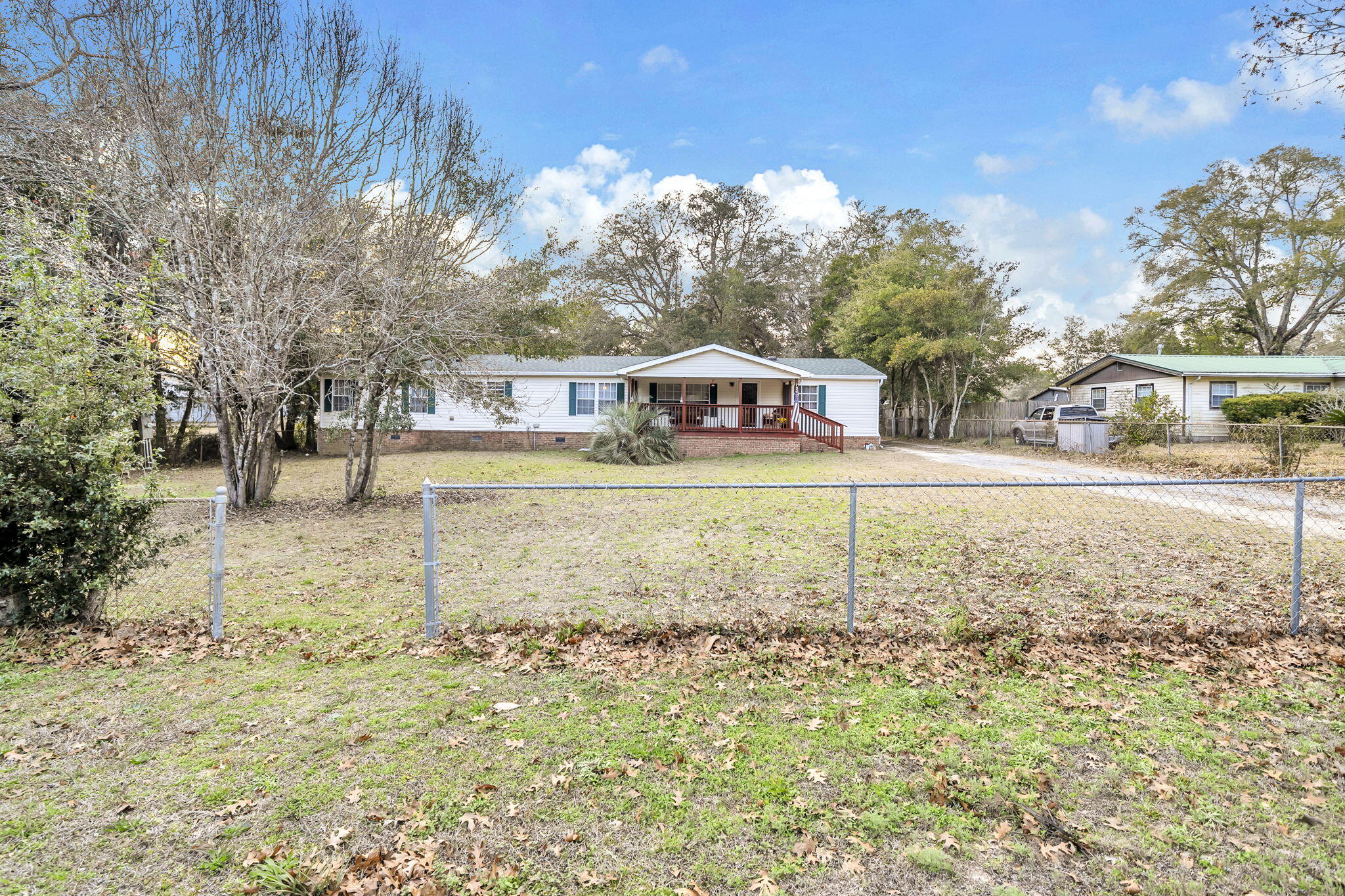 1422 Cat-Mar Road Niceville, FL 32578 - Photo 4 of 35 a view of a house with a yard and trees