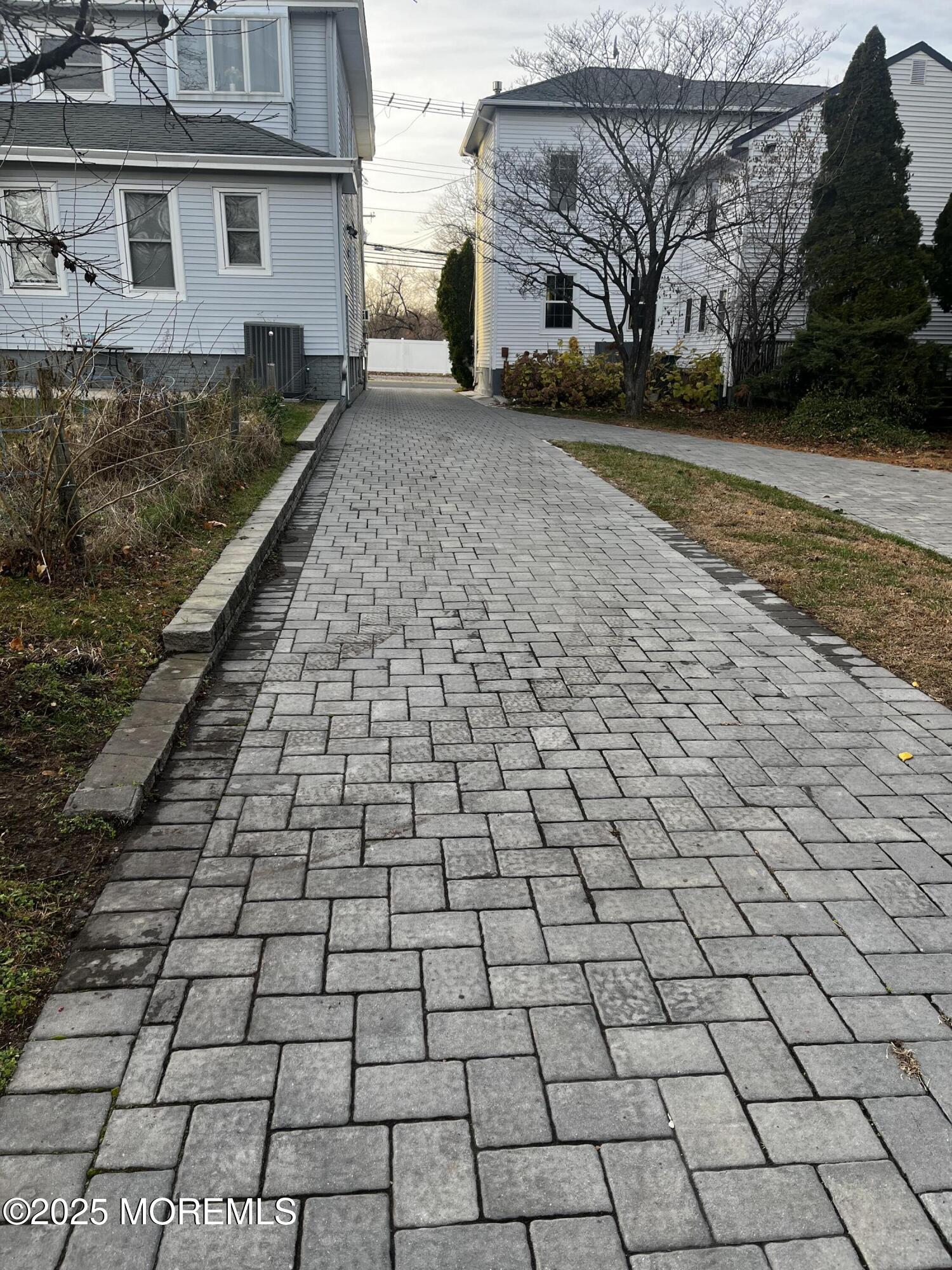 103 Main Street, Unit 1 Matawan, NJ 07747 - Photo 11 of 12 a view of a yard with brick house