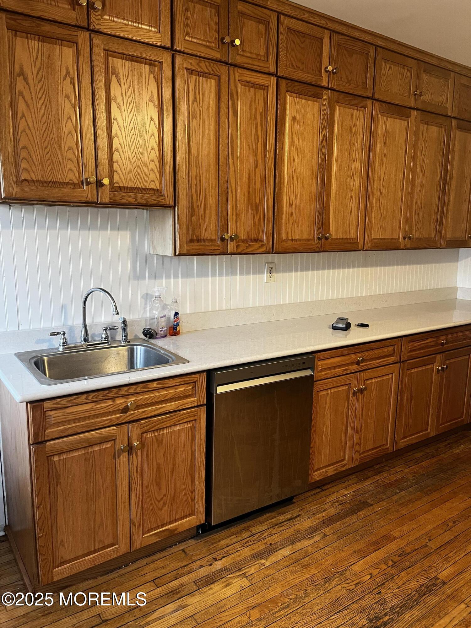 103 Main Street, Unit 1 Matawan, NJ 07747 - Photo 7 of 12 a kitchen with stainless steel appliances granite countertop wooden cabinets a sink and dishwasher