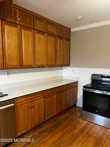 a kitchen with stainless steel appliances wooden cabinets and a sink