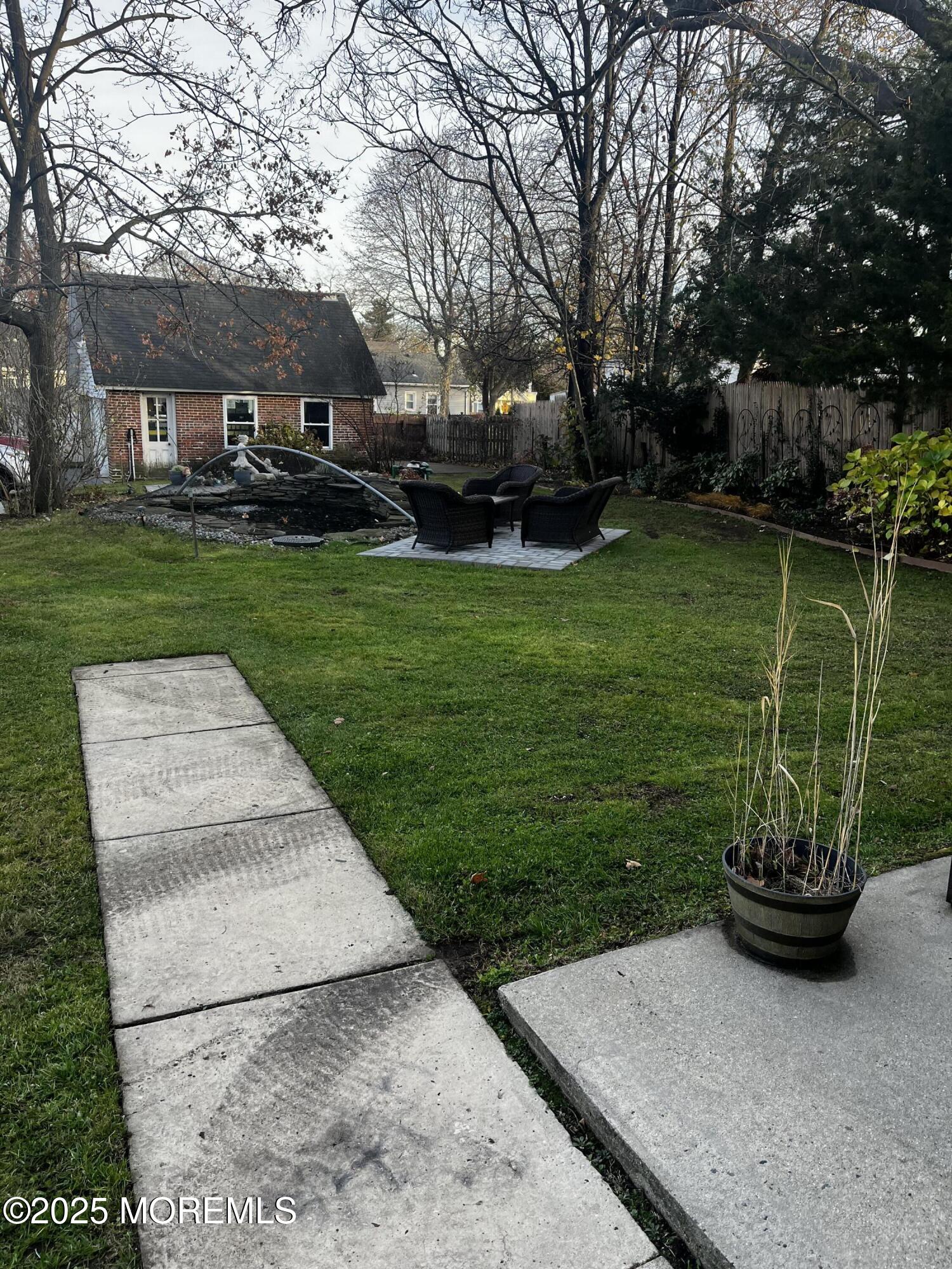 103 Main Street, Unit 1 Matawan, NJ 07747 - Photo 9 of 12 a view of a backyard with sitting area