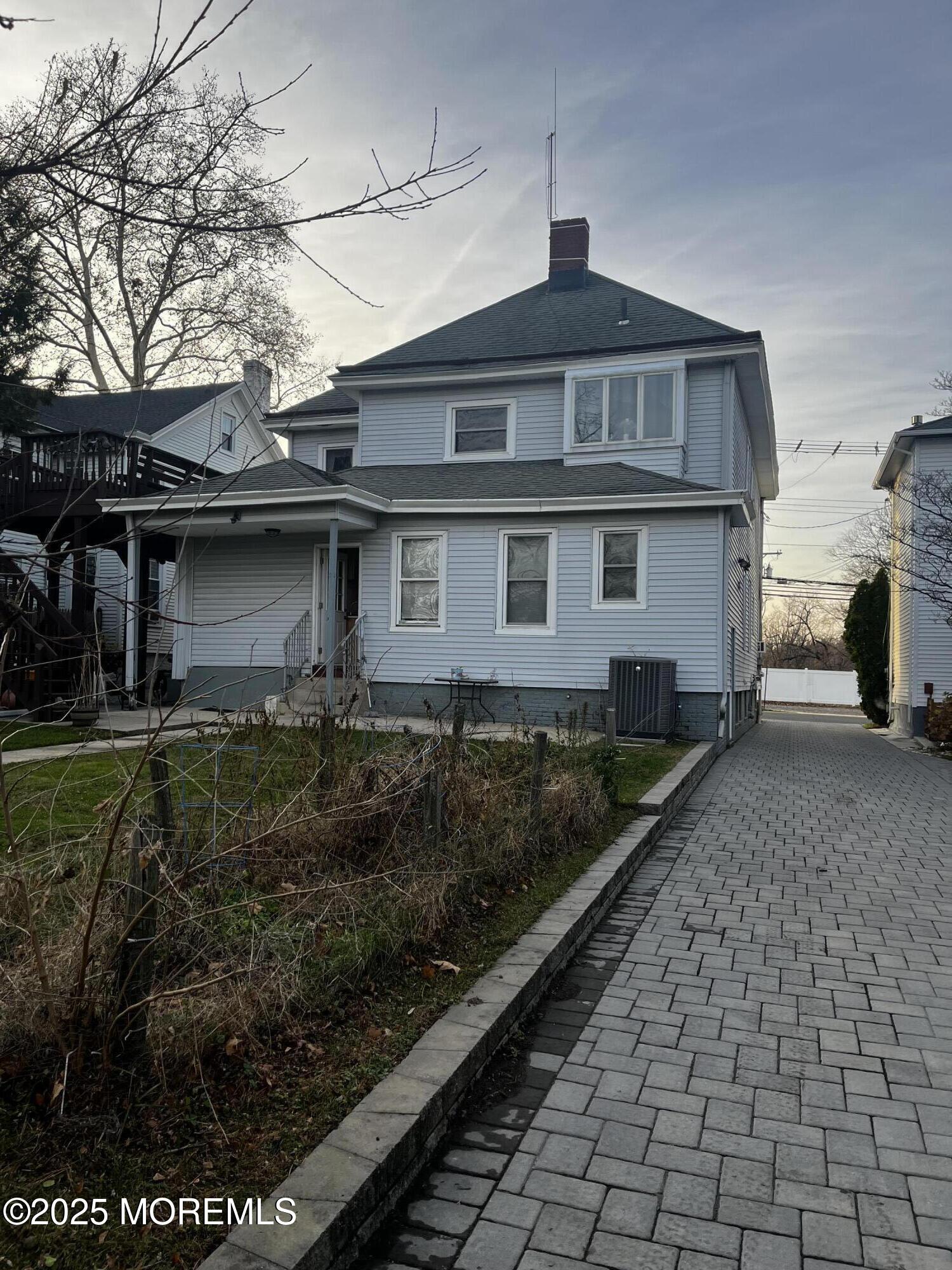 103 Main Street, Unit 1 Matawan, NJ 07747 - Photo 10 of 12 a front view of a house with a yard