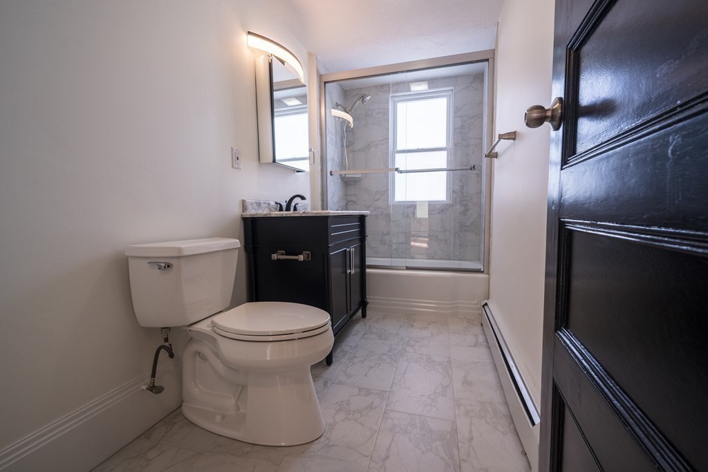 302 Summit Avenue, Unit 1 Boston, MA 02135 - Photo 11 of 13 a bathroom with a toilet and a shower