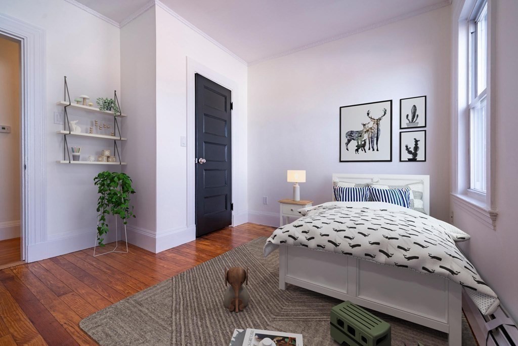 302 Summit Avenue, Unit 1 Boston, MA 02135 - Photo 9 of 13 a bedroom with a bed and a potted plant