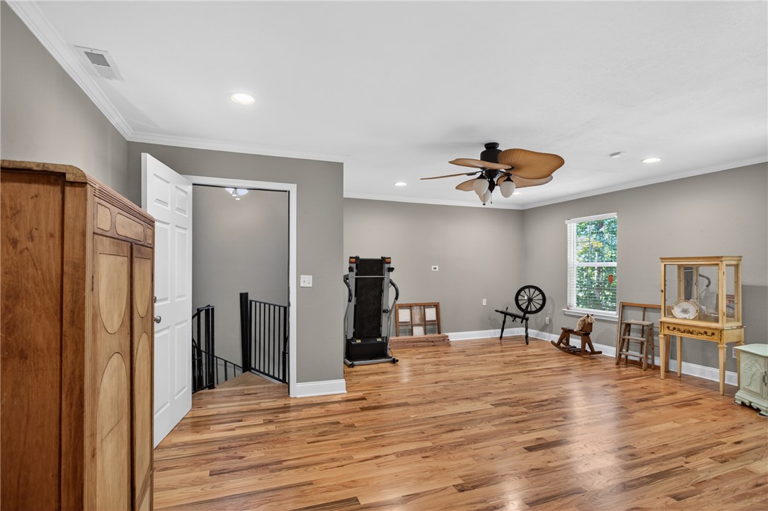 151 Towne Creek Trail Anderson, SC 29621 - Photo 29 of 49 A versatile open-concept space features warm hardwood flooring, crown molding, and a charming ceiling fan.