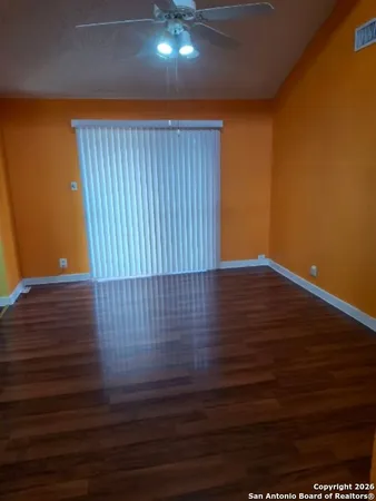 a view of a room with wooden floor
