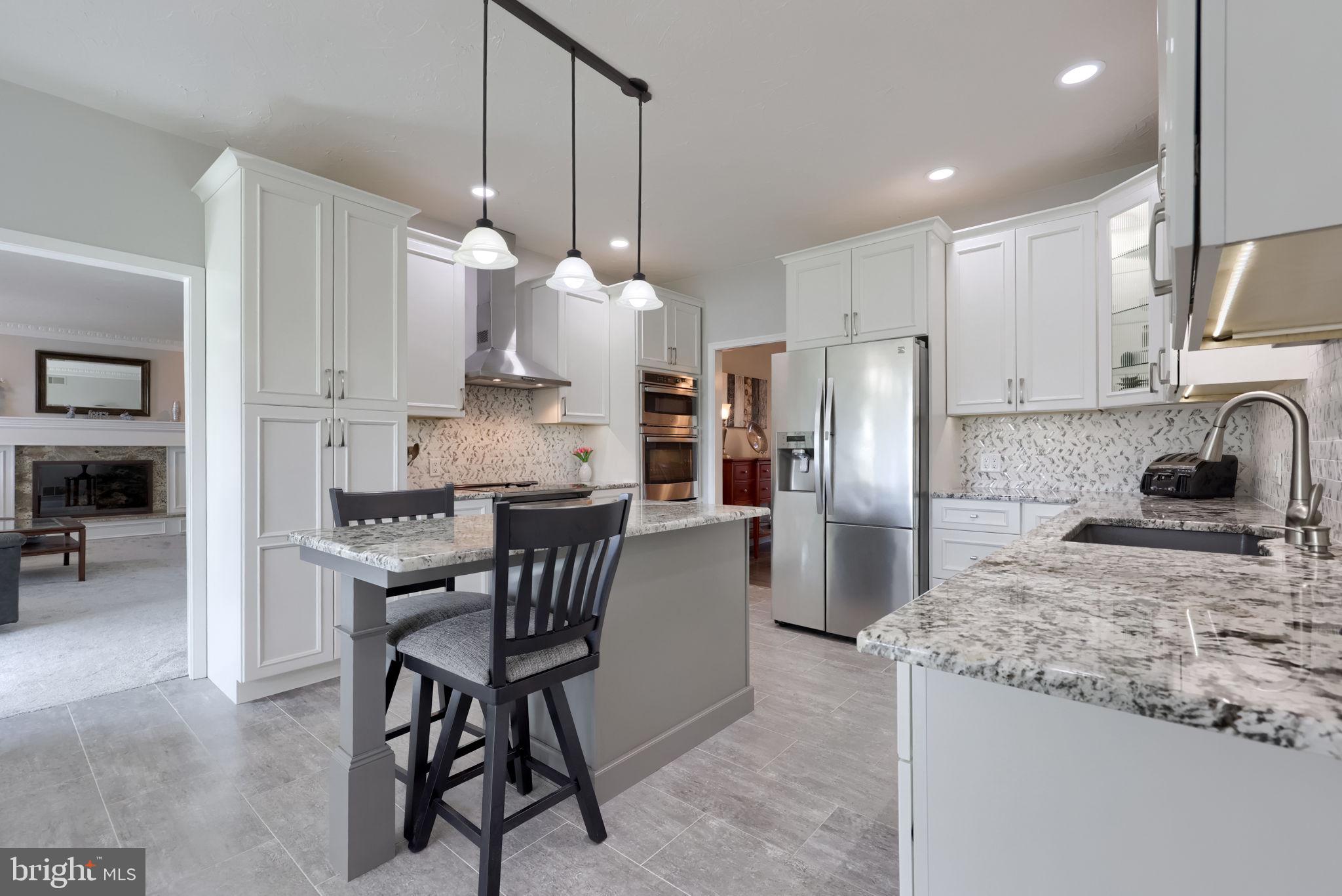 2702 Chestnut Run Road York, PA 17402 - Photo 12 of 65 a kitchen with stainless steel appliances granite countertop a sink a stove a refrigerator a center island a dining table and chairs