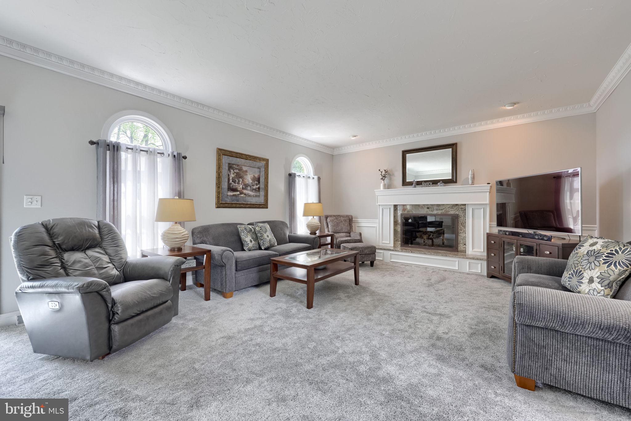 2702 Chestnut Run Road York, PA 17402 - Photo 24 of 65 a living room with furniture a large window and a fireplace