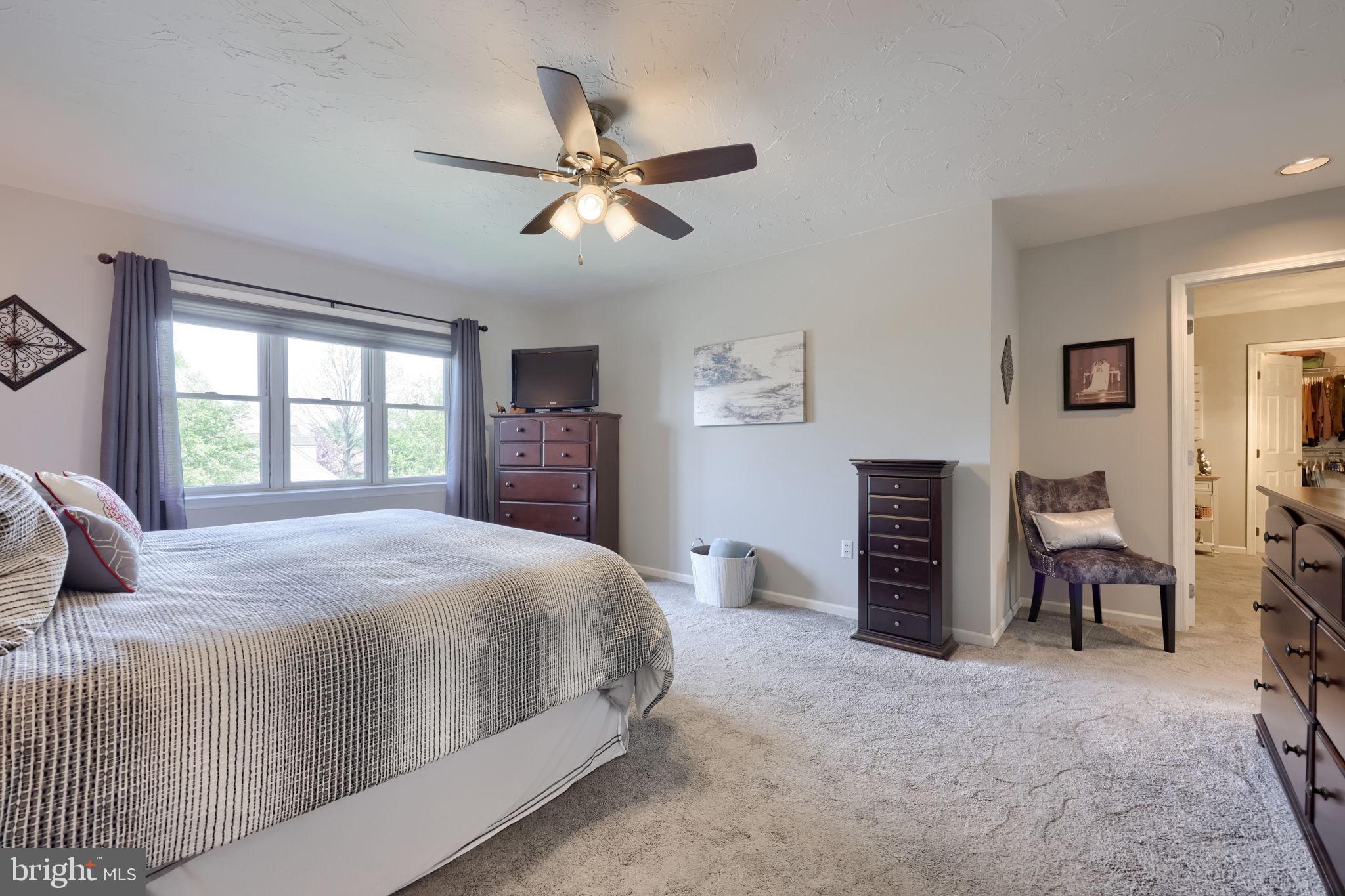 2702 Chestnut Run Road York, PA 17402 - Photo 30 of 65 a bedroom with a large bed and a chandelier