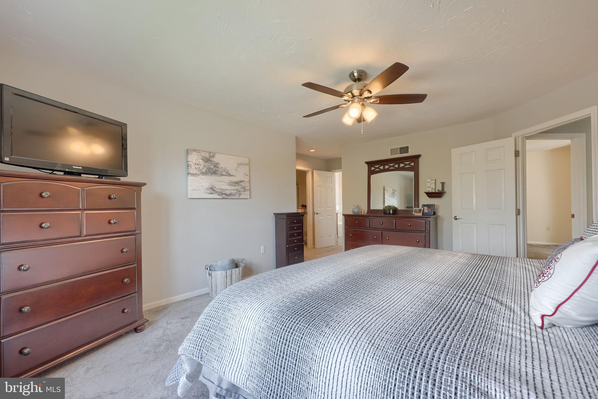 2702 Chestnut Run Road York, PA 17402 - Photo 32 of 65 a bedroom with a large bed and a flat screen tv