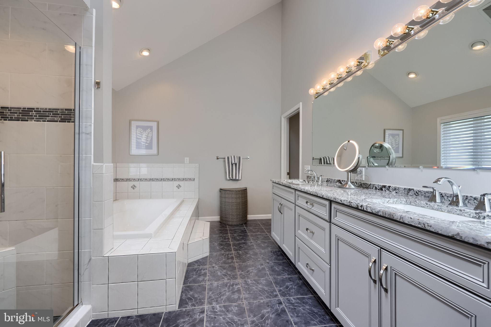 2702 Chestnut Run Road York, PA 17402 - Photo 36 of 65 a bathroom with a granite countertop double vanity sink a mirror and a shower