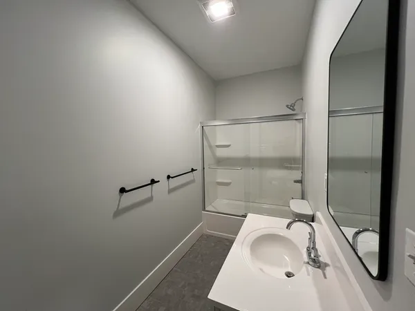a bathroom with a tub sink and shower