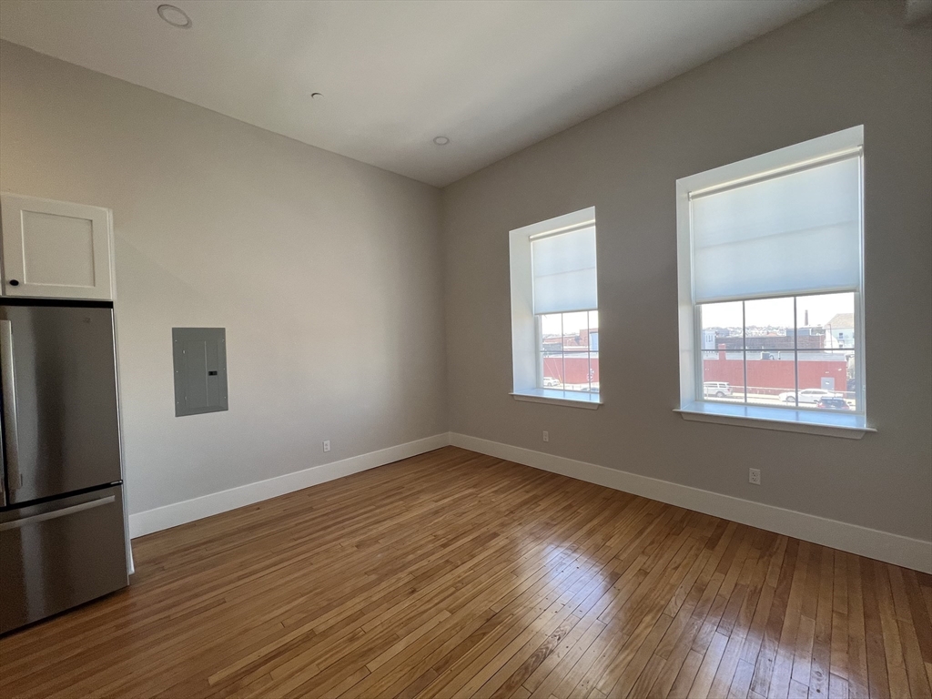 34 St Joseph Street, Unit 23 Fall River, MA 02723 - Photo 8 of 19 a view of an empty room with wooden floor and a window