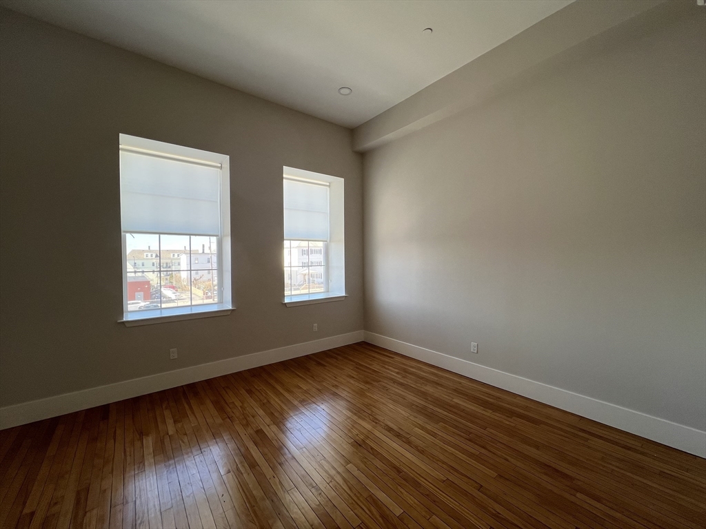 34 St Joseph Street, Unit 23 Fall River, MA 02723 - Photo 9 of 19 a view of an empty room with wooden floor and a window