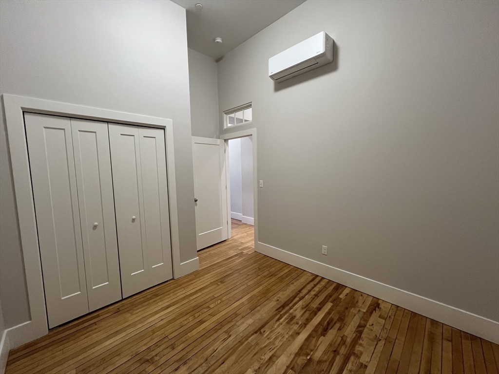34 St Joseph Street, Unit 23 Fall River, MA 02723 - Photo 10 of 19 a view of an empty room with wooden floor and a window