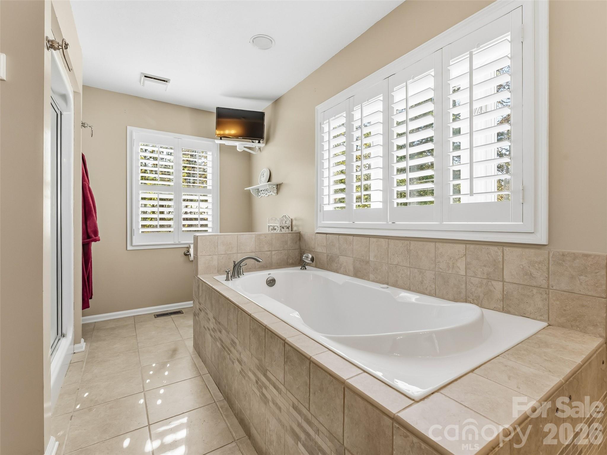 1340 Macedonia Road Saluda, NC 28773 - Photo 26 of 45 a bath tub sitting in a bathroom next to a window