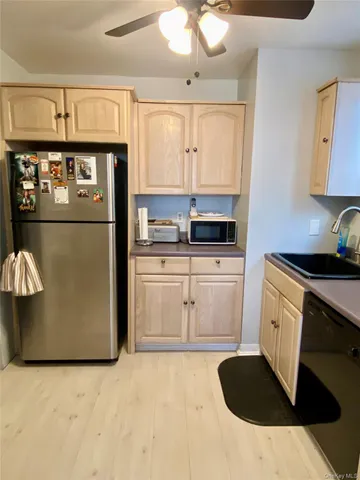 a bedroom with a bed and dresser with mirror