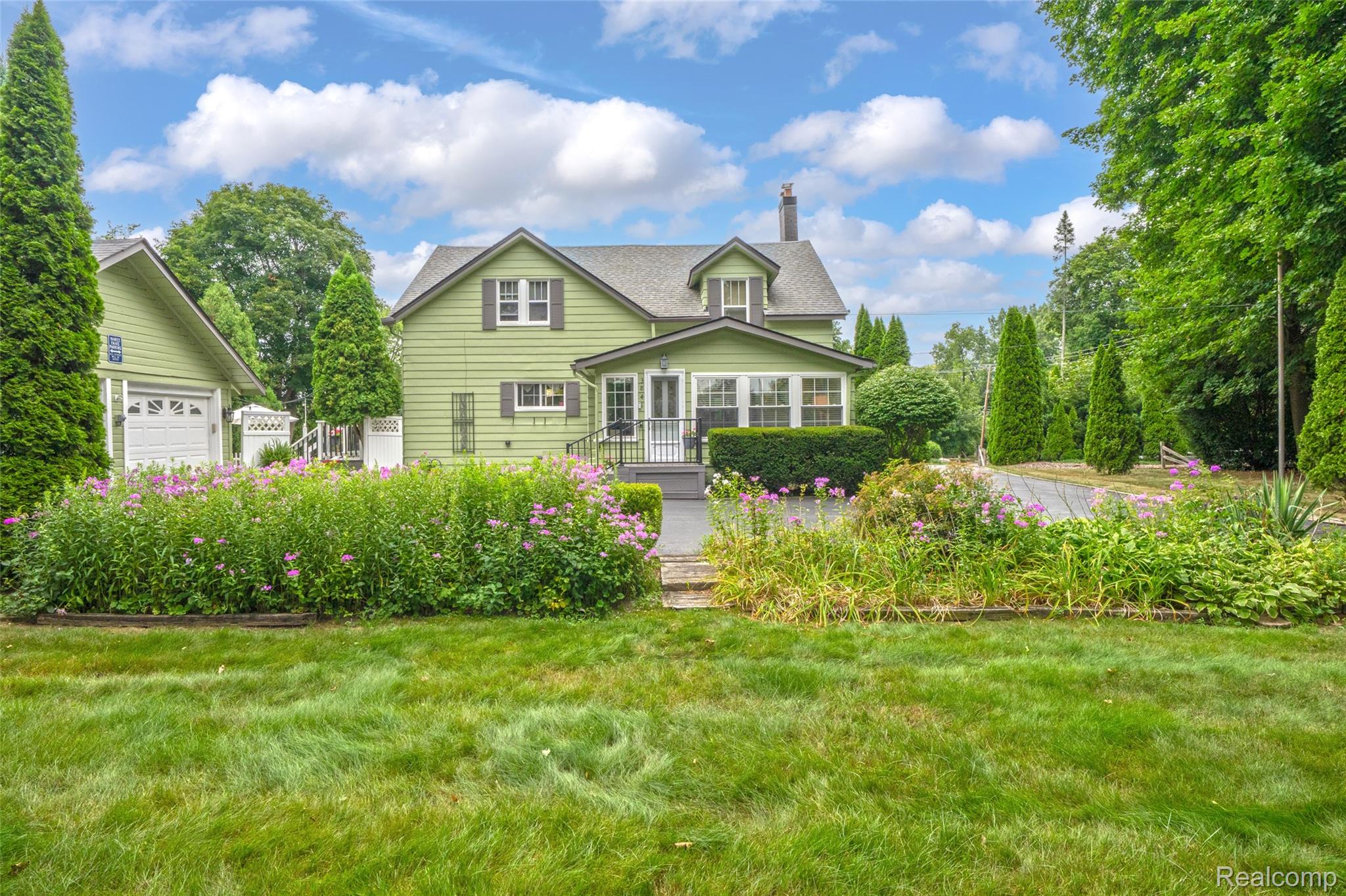 3841 Covert Road Waterford, MI 48328 - Photo 46 of 87 Expansive grassy lawn with established garden beds and mature trees