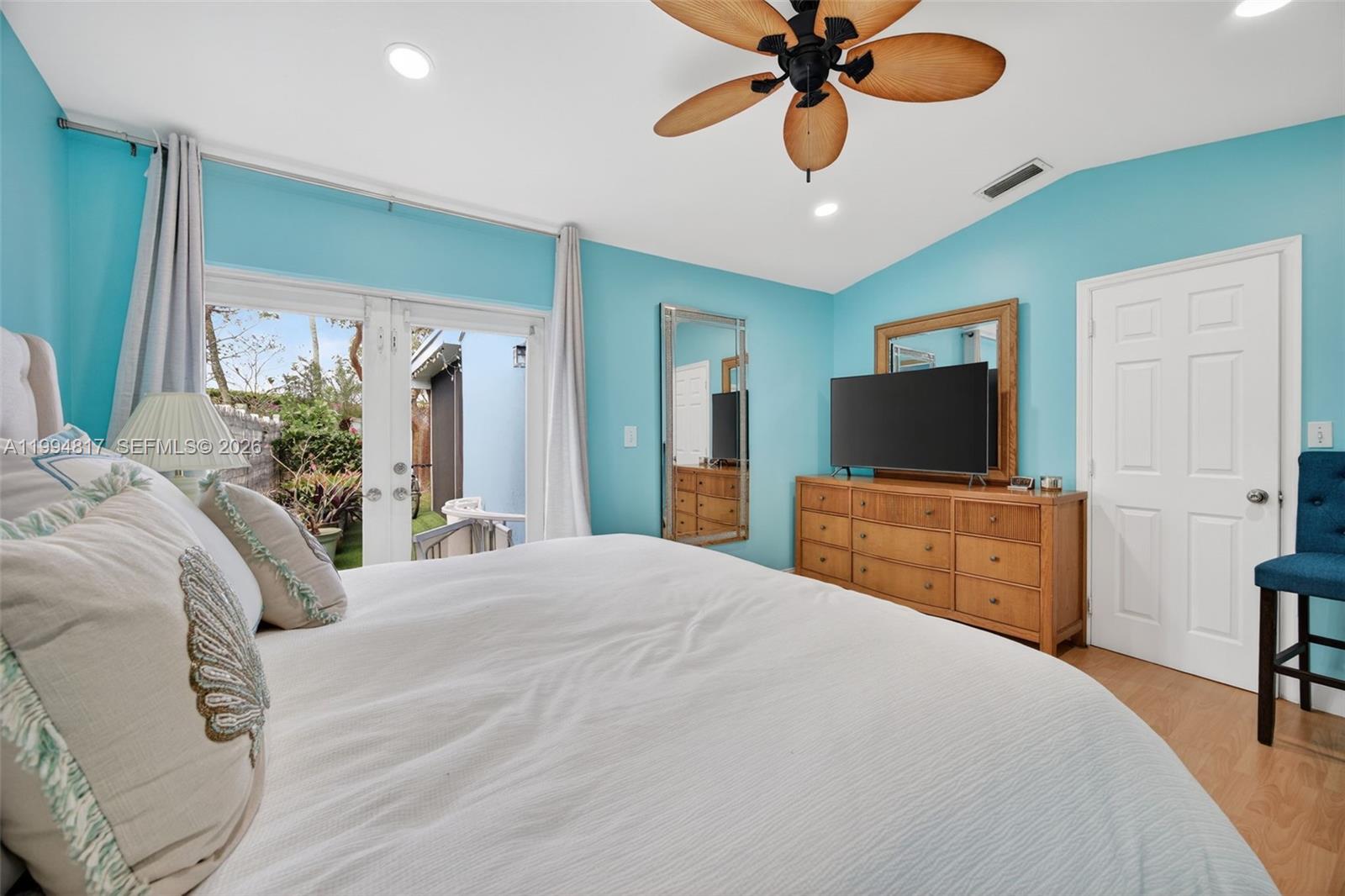 14610 Southwest 145th Place Miami, FL 33186 - Photo 16 of 52 a bedroom with a bed and a flat screen tv