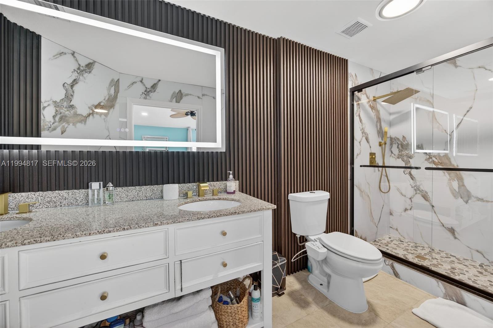 14610 Southwest 145th Place Miami, FL 33186 - Photo 20 of 52 a bathroom with a granite countertop sink toilet and painting on the wall