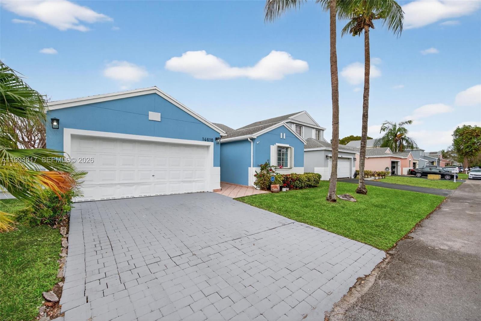 14610 Southwest 145th Place Miami, FL 33186 - Photo 3 of 52 a front view of a house with a yard and garage