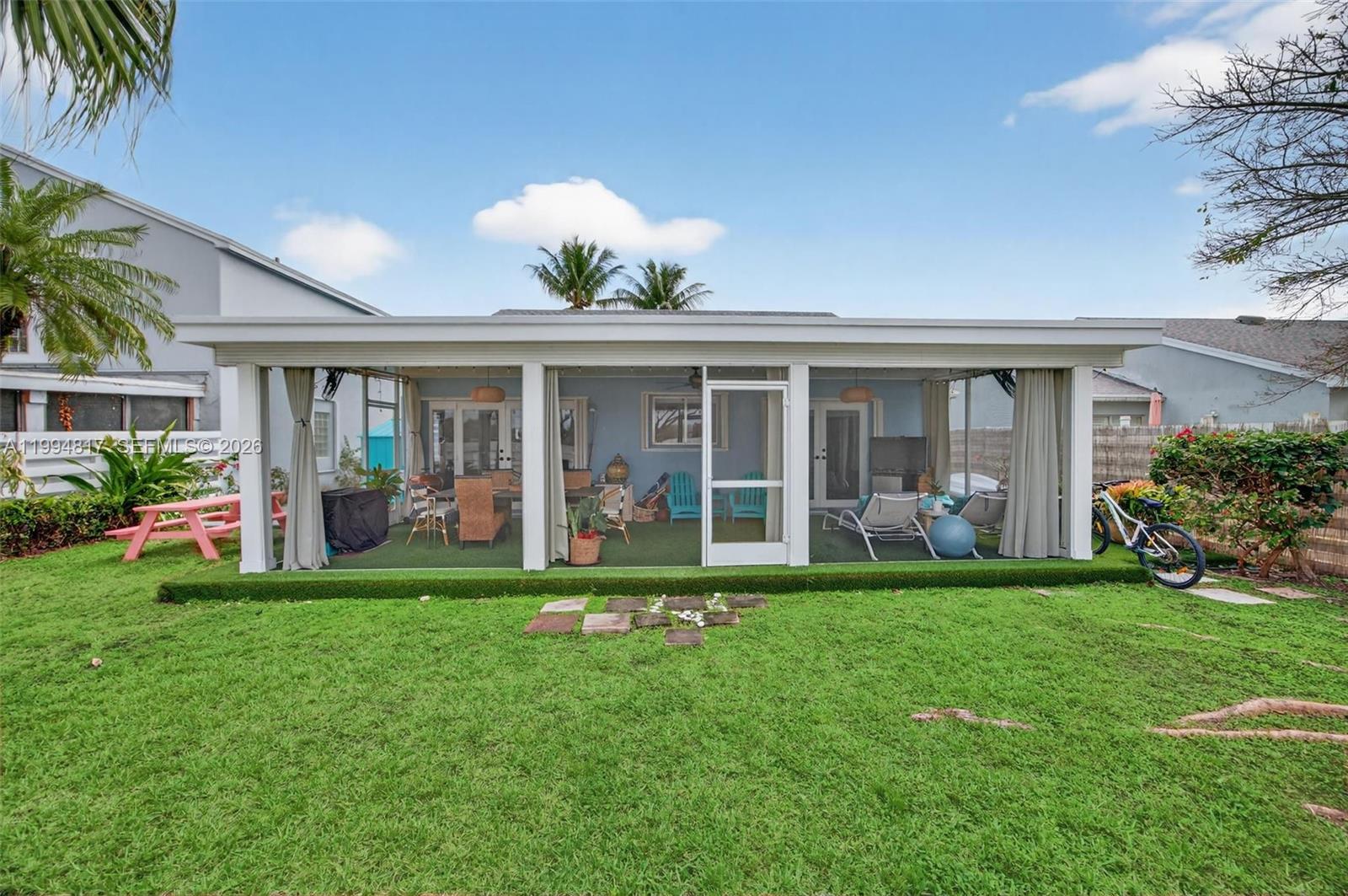 14610 Southwest 145th Place Miami, FL 33186 - Photo 39 of 52 a front view of a house with a garden and yard