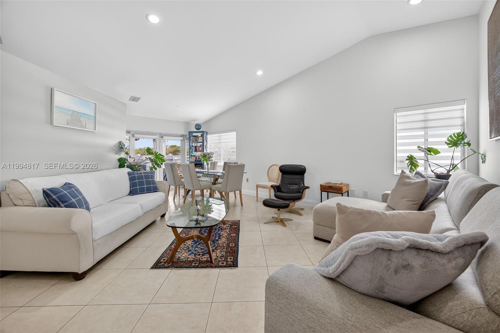 14610 Southwest 145th Place Miami, FL 33186 - Photo 6 of 52 a living room with furniture and a flat screen tv