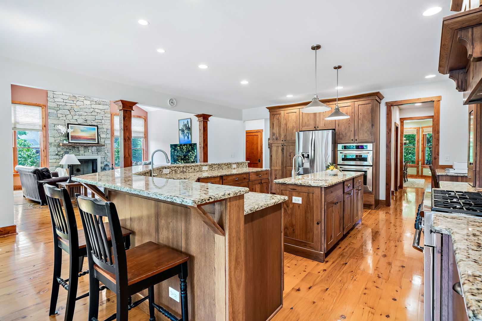 4511 Cumnor Road Downers Grove, IL 60515 - Photo 11 of 42 a kitchen with granite countertop a stove a sink a dining table and chairs
