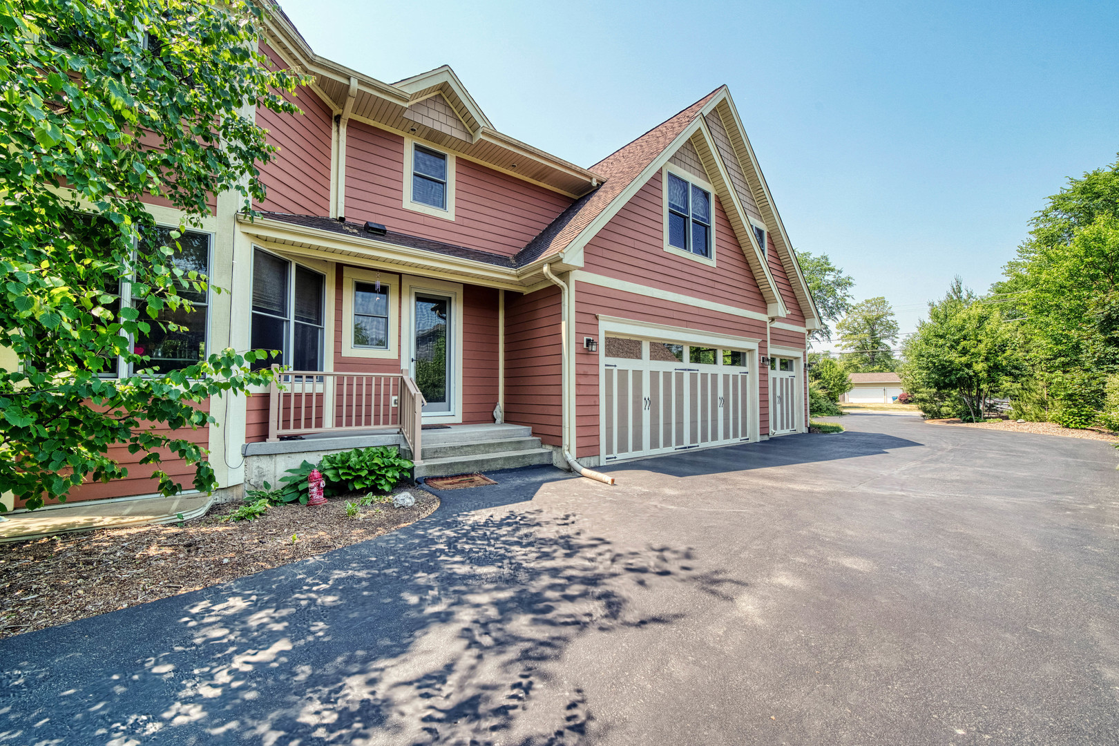 4511 Cumnor Road Downers Grove, IL 60515 - Photo 38 of 42 a view of a brick house with large windows plants and large trees