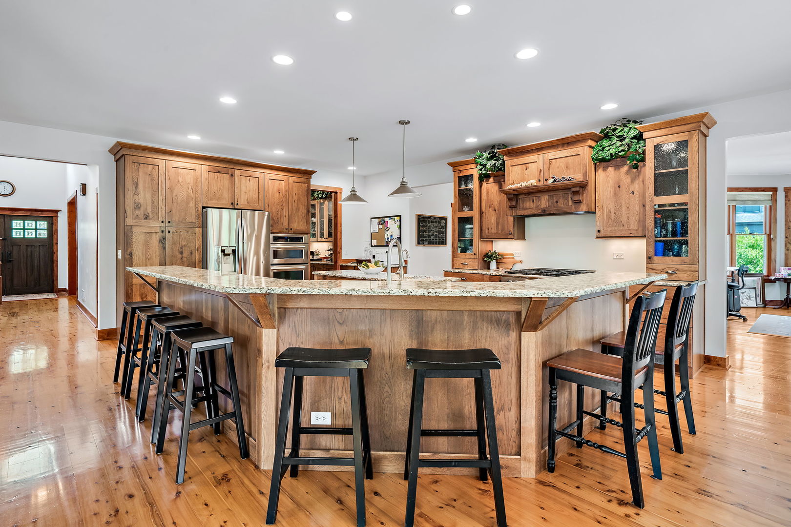 4511 Cumnor Road Downers Grove, IL 60515 - Photo 9 of 42 a kitchen with stainless steel appliances kitchen island granite countertop a table chairs and a refrigerator