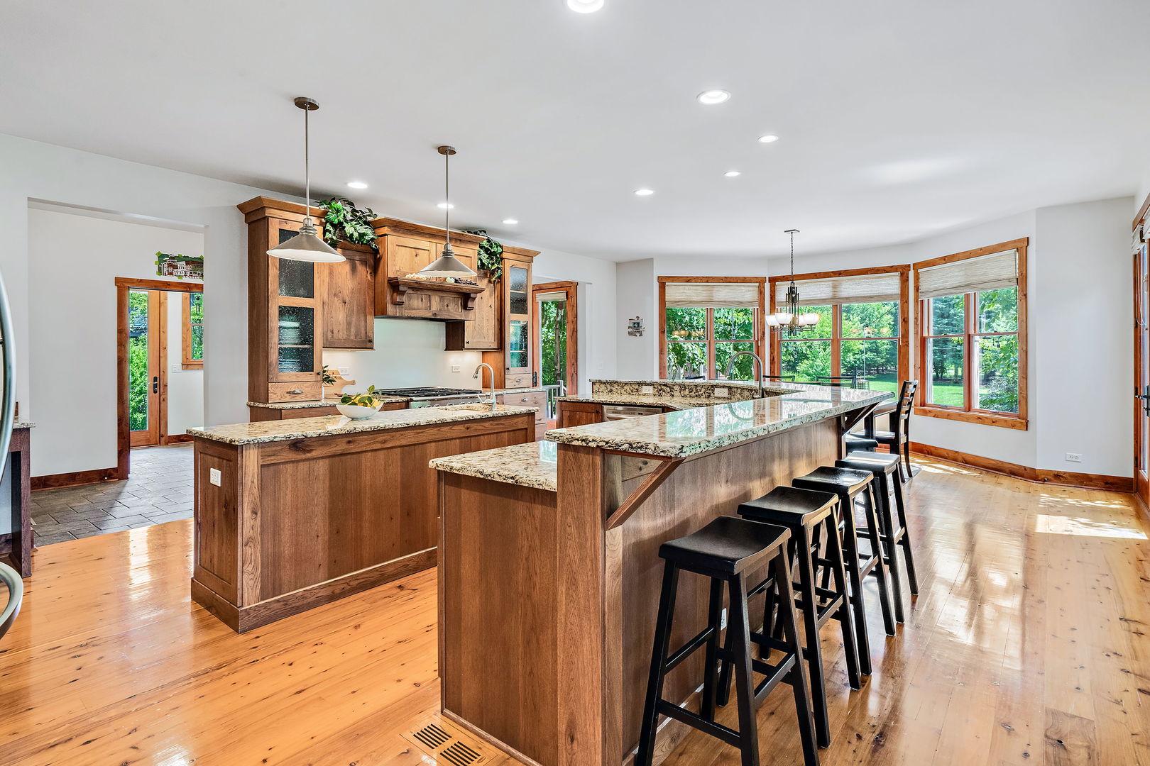 4511 Cumnor Road Downers Grove, IL 60515 - Photo 10 of 42 a kitchen with stainless steel appliances kitchen island granite countertop a stove and a wooden floors
