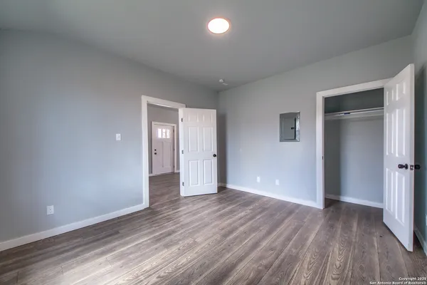a view of wooden floor and windows in a room