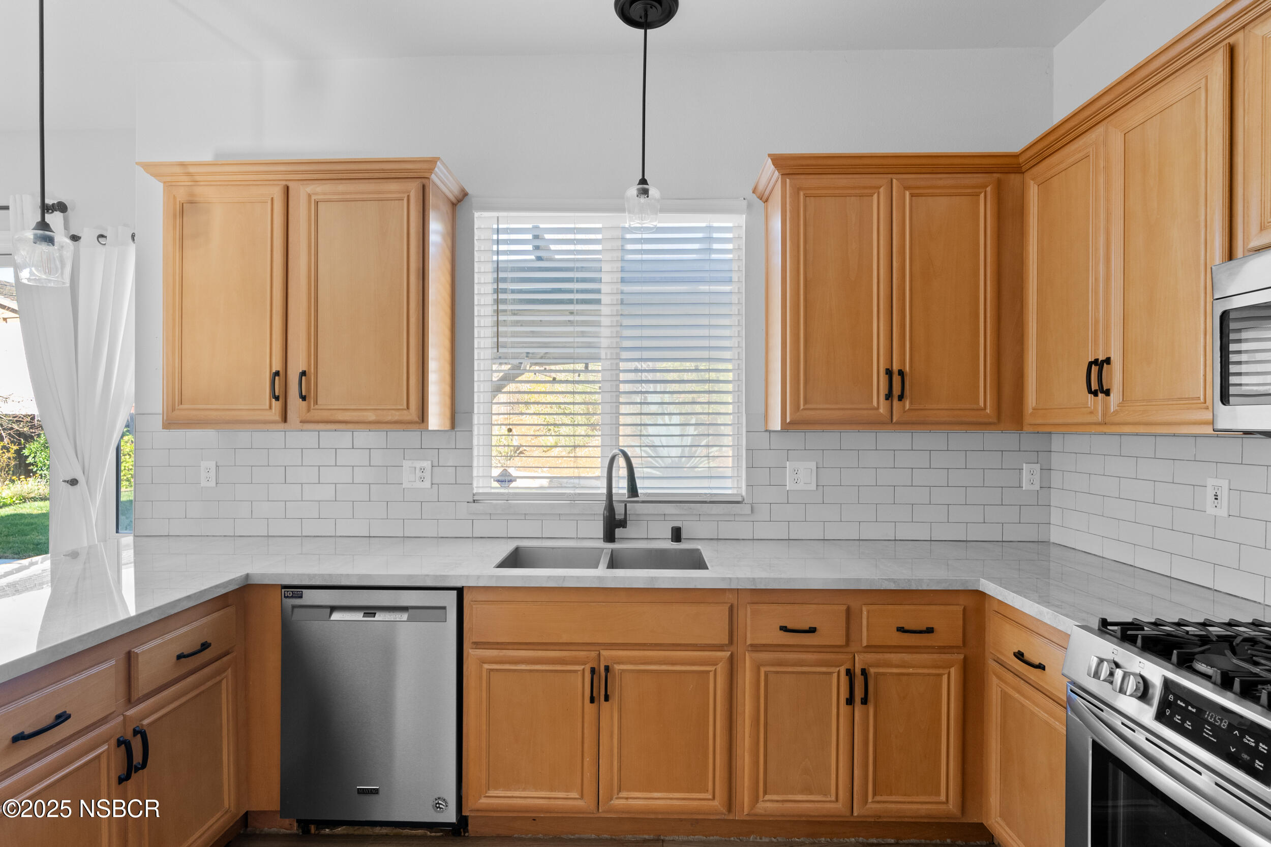 608 Celestial Way Lompoc, CA 93436 - Photo 12 of 40 a kitchen with stainless steel appliances granite countertop a sink a stove and a refrigerator