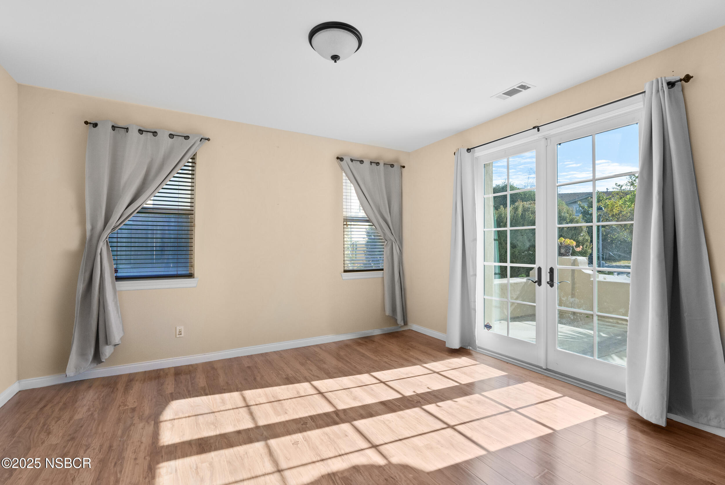 608 Celestial Way Lompoc, CA 93436 - Photo 17 of 40 a view of an empty room with wooden floor and windows