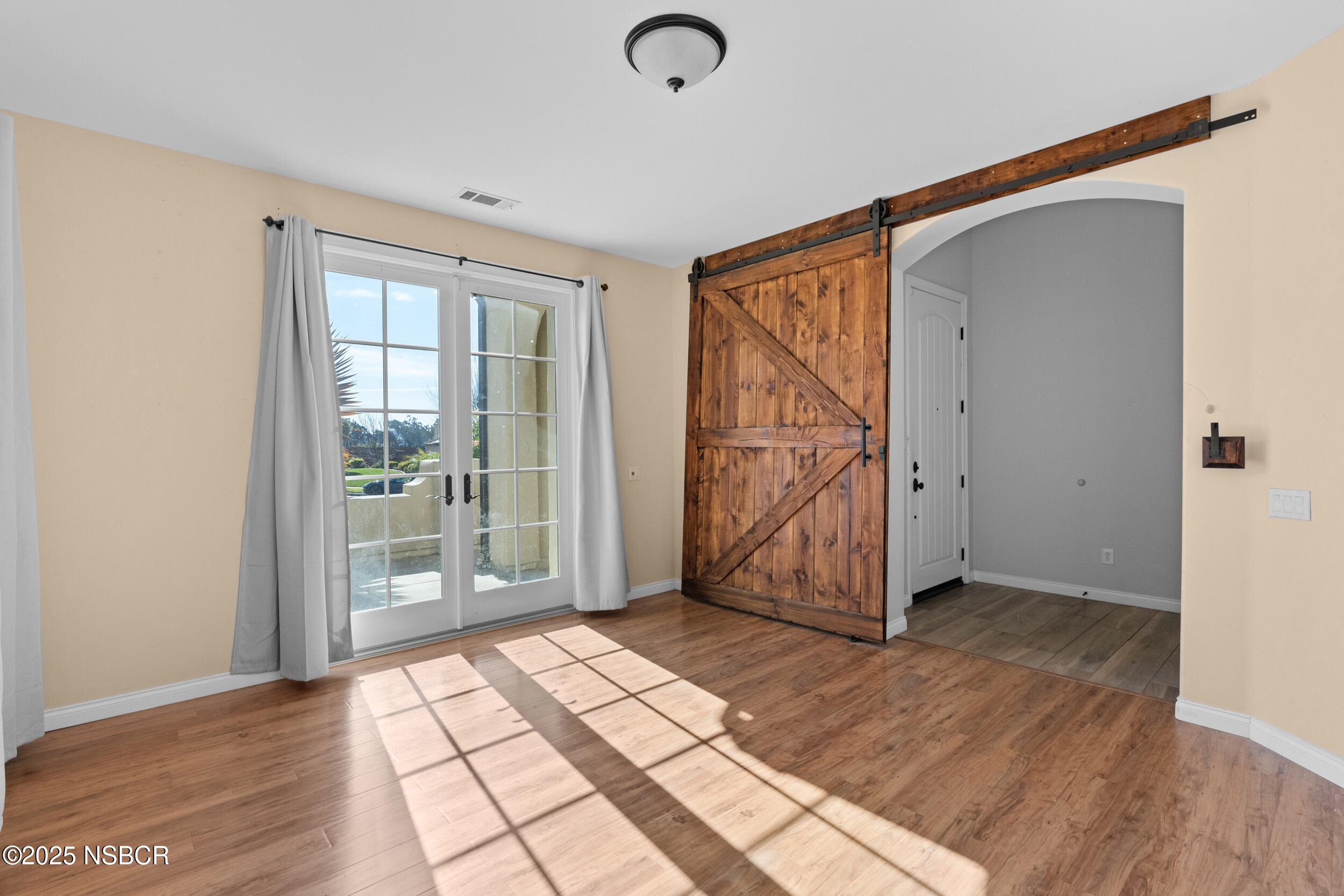 608 Celestial Way Lompoc, CA 93436 - Photo 18 of 40 an empty room with wooden floor and windows