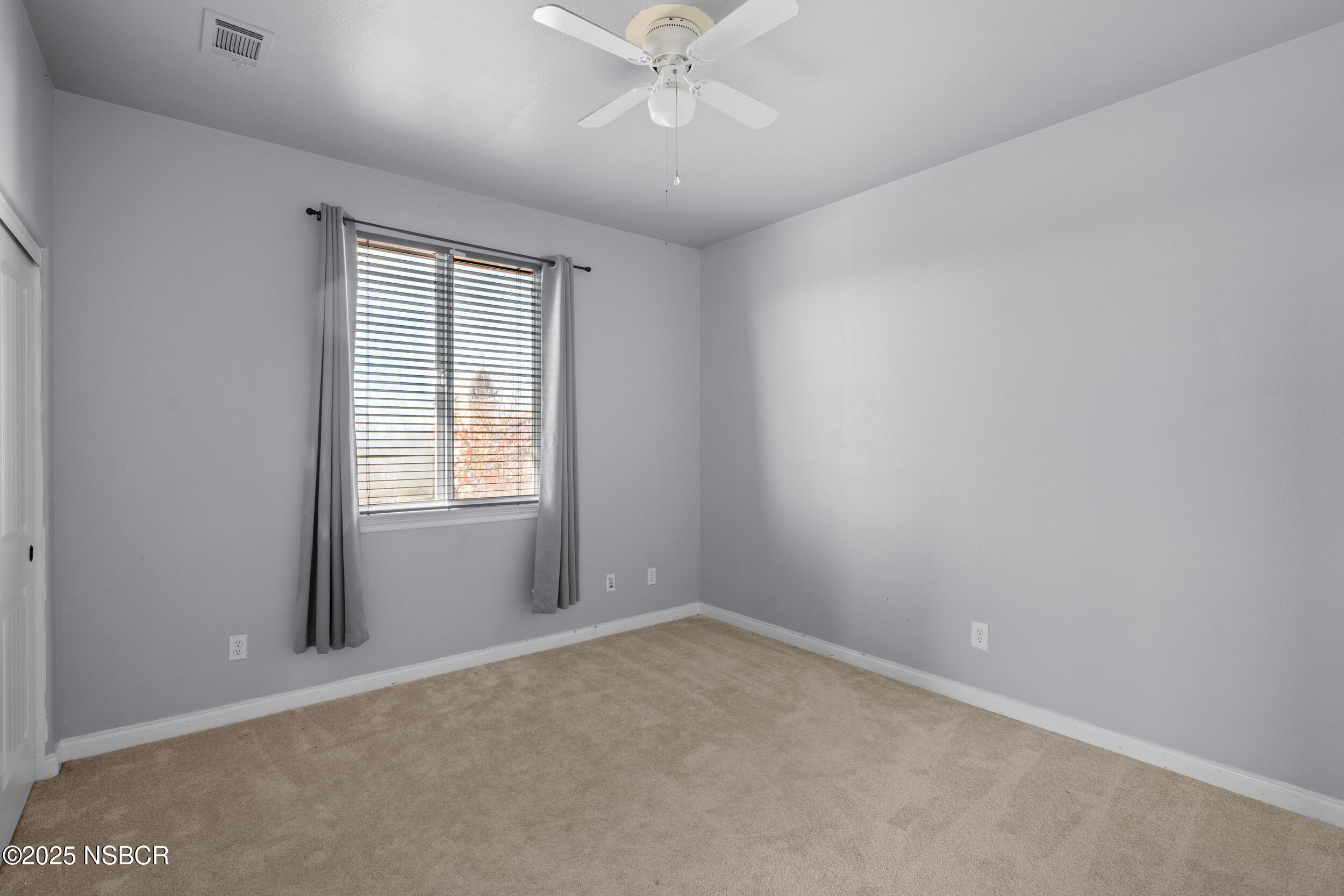 608 Celestial Way Lompoc, CA 93436 - Photo 21 of 40 an empty room with a window and a fan