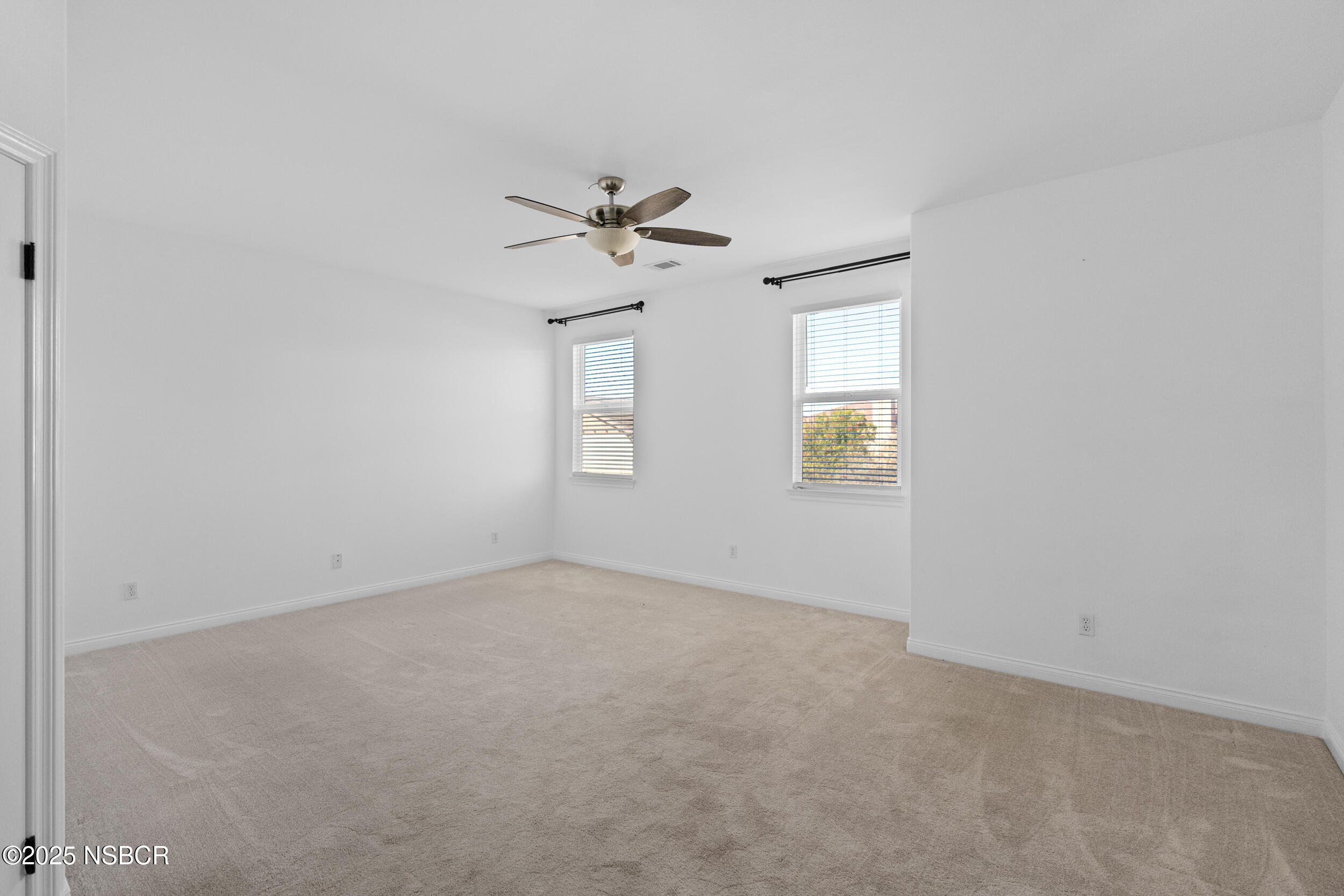 608 Celestial Way Lompoc, CA 93436 - Photo 28 of 40 an empty room with windows and chandelier fan