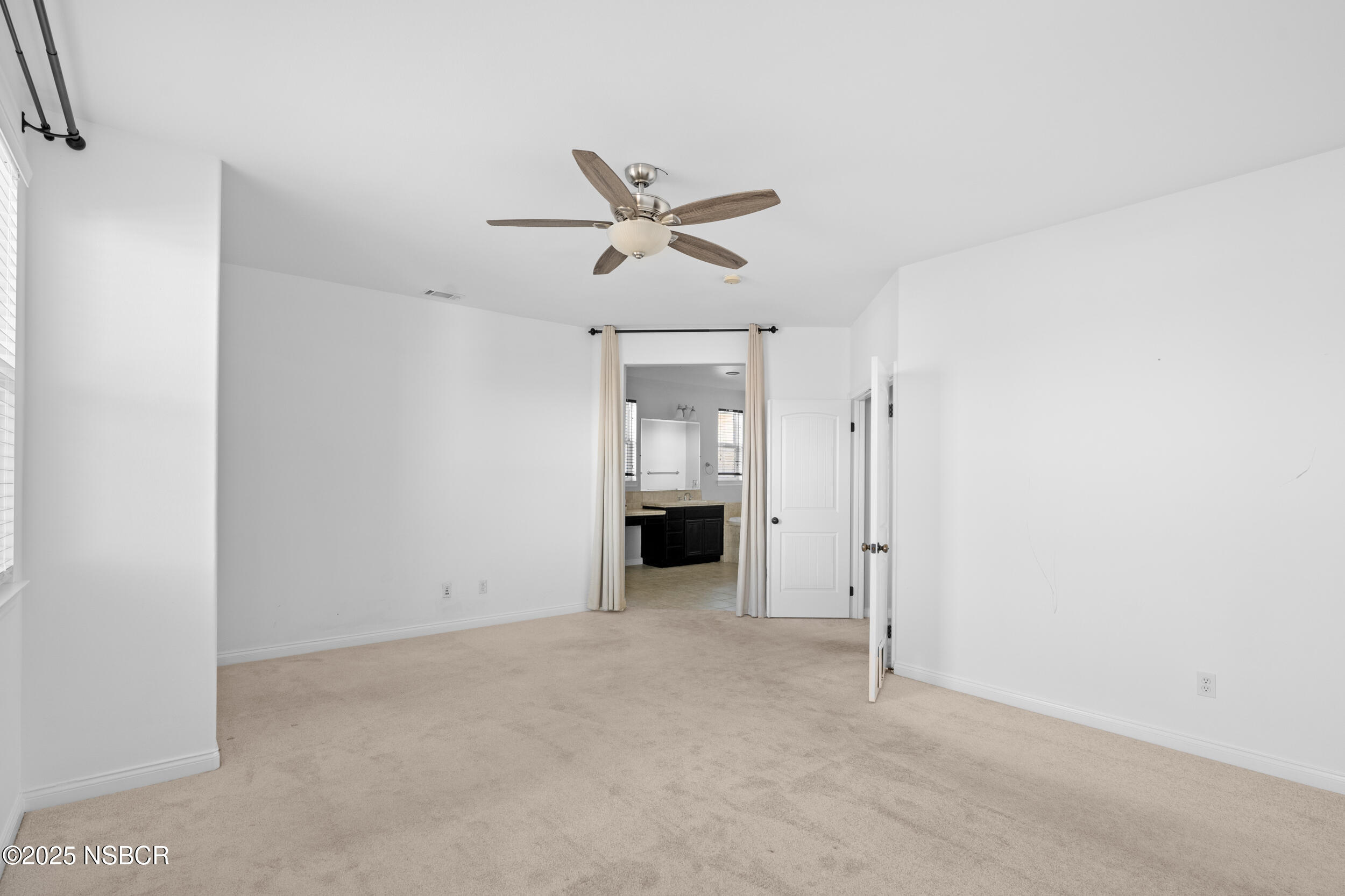 608 Celestial Way Lompoc, CA 93436 - Photo 31 of 40 an empty room with a ceiling fan and window