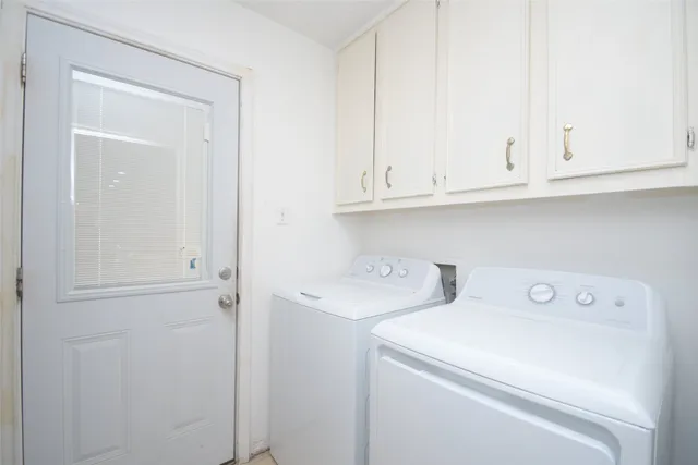 a bedroom with a bed chair and white walls